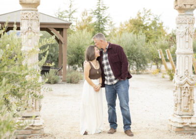 husband kissing his wife on the forehead at allegretto vineyard resort