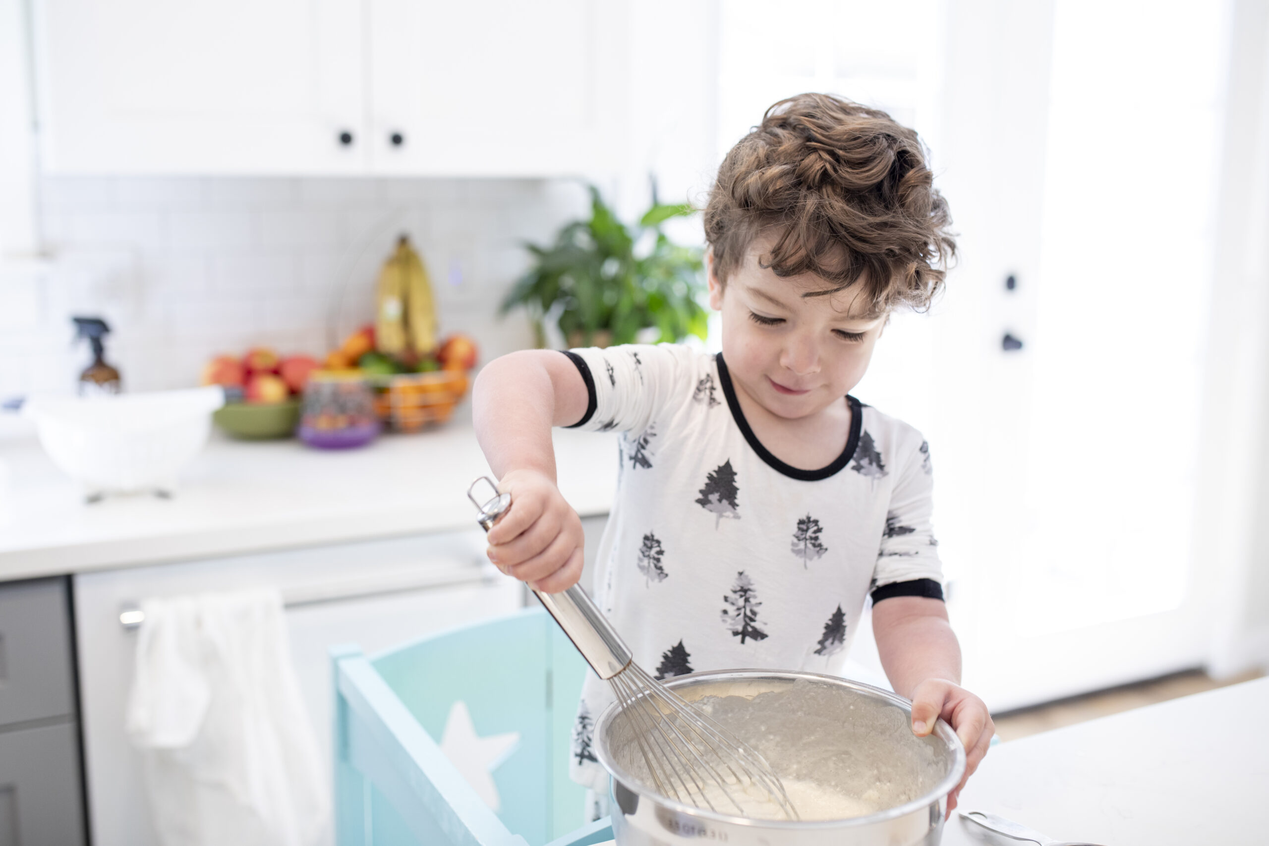 young boy stirring pancake batter
