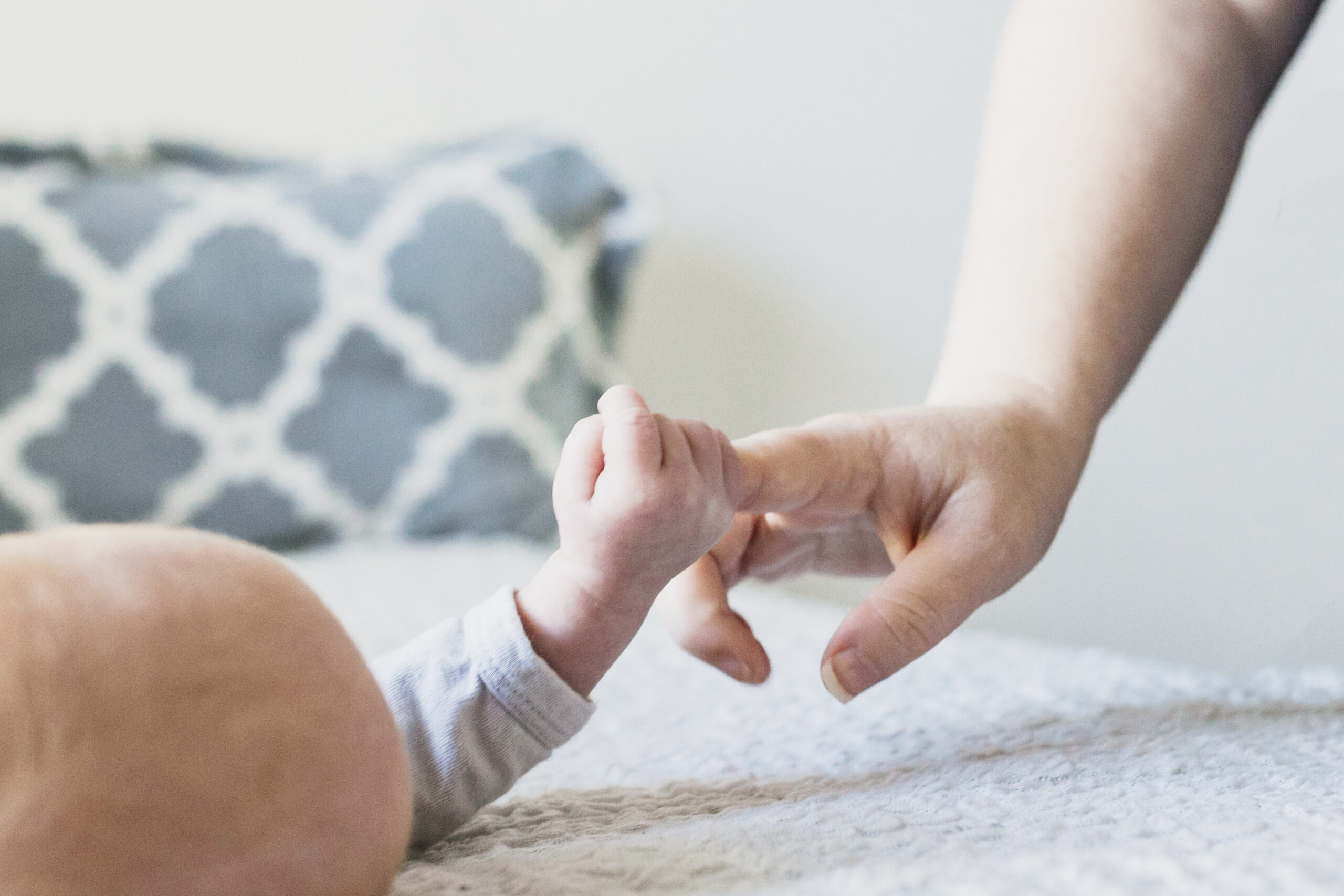 newborn hand gripping mom's finger