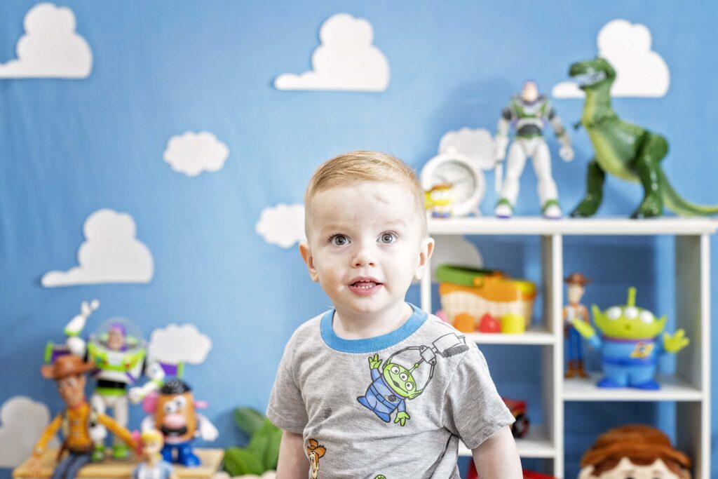 Two year old boy in a Toy Story themed set