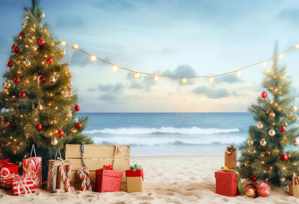 Christmas beach theme with christmas trees and gifts in the sand at the beach