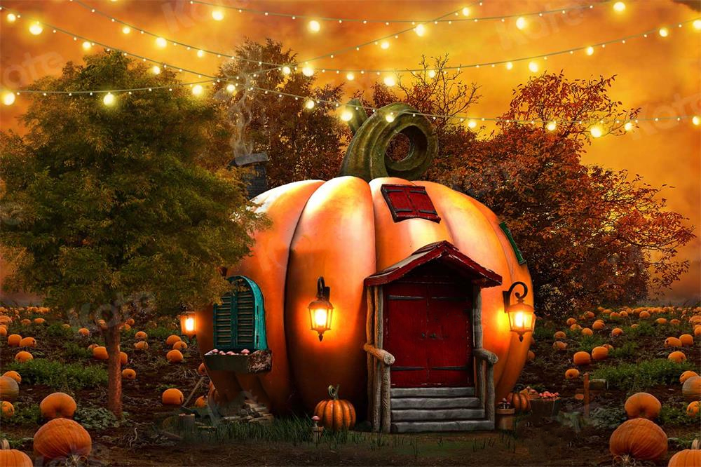 Halloween themed backdrop with a large pumpkin house.