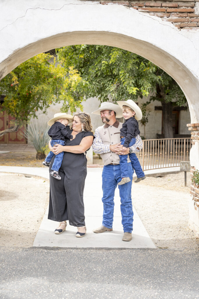 family of four at the entrance to the mission San Miguel
