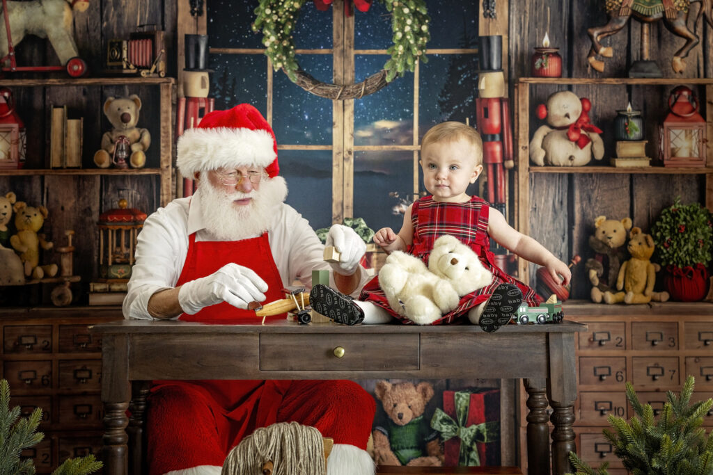 one year old girl playing with Santa Claus